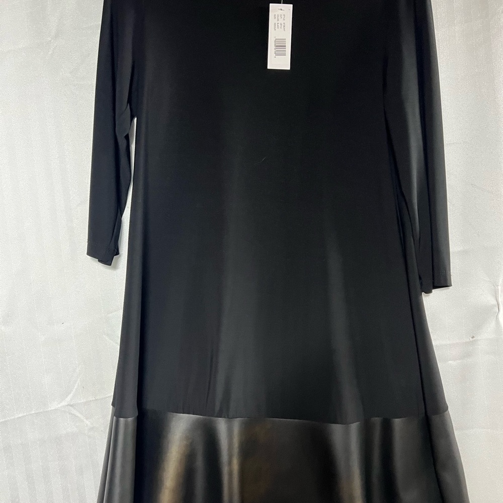 This is your basic little black dress w/a pleather strip around the bottom.